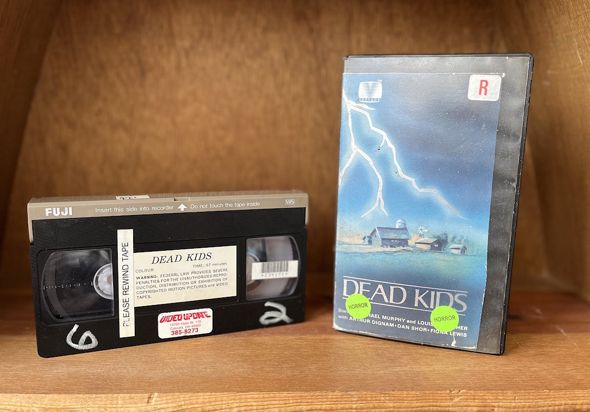 The VHS box cover and its tape for Dead Kids.
